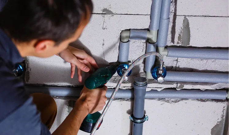 Plumber repairing interior water supply piping