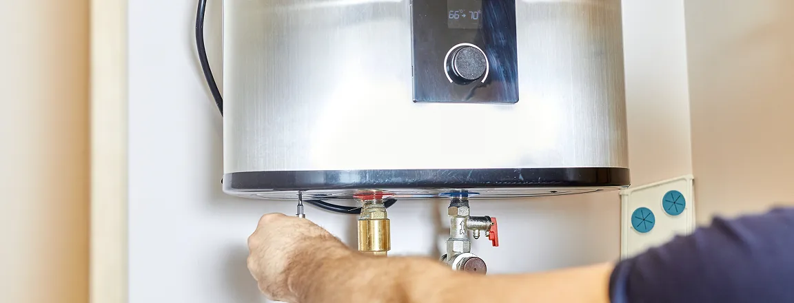 Close-up of residential water heater lower access panel