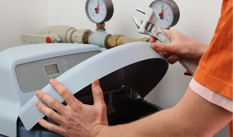 Technician servicing residential water softener system